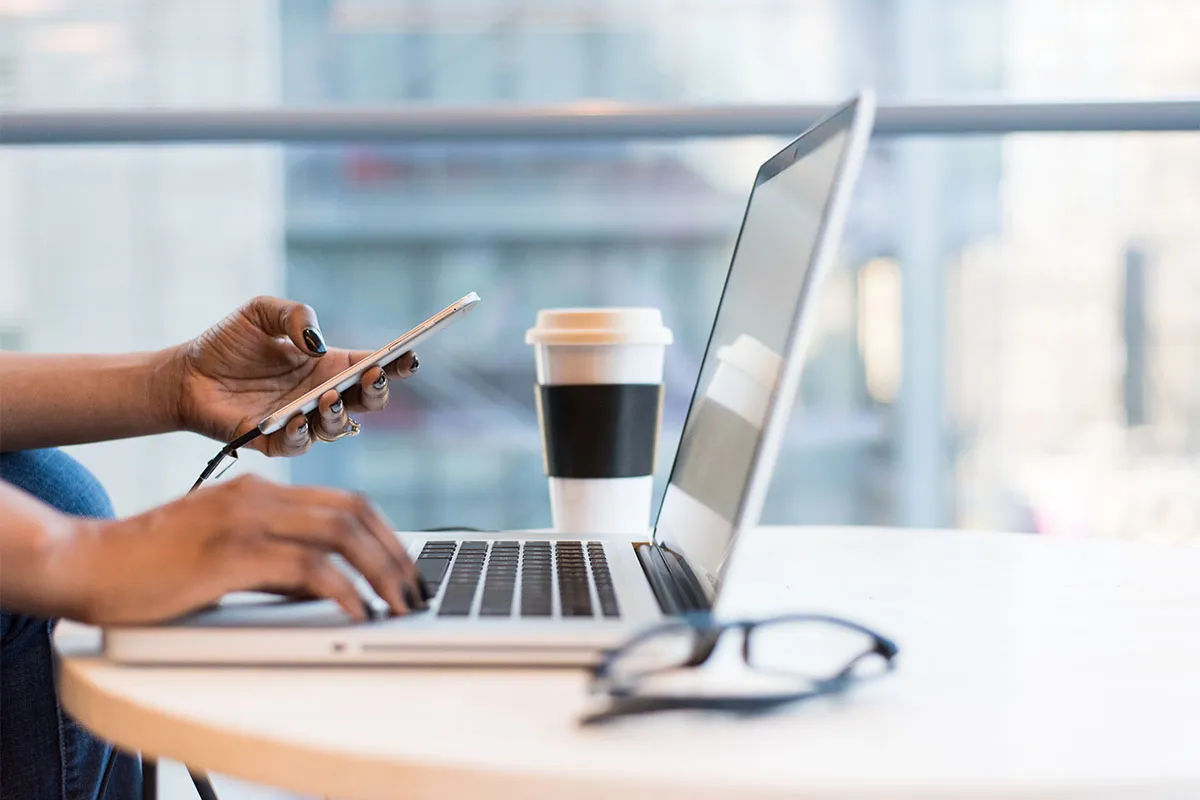 A photograph of a woman using a laptop
